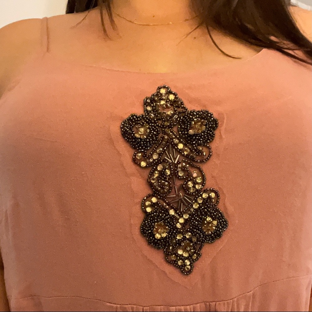 Pale pink dressy tank with jewel detail.
